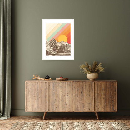White framed archival print with a graphic design feel, featuring a stark mountain range under a large sun, overlaid with colourful diagonal stripes in pastel orange, yellow, and green.