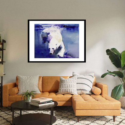 Black framed 'Underwater Bear' by Mark Adlington. This artwork portrays a polar bear gracefully swimming beneath icy blue waters. Available as archival digital print, it's a stunning addition to any collection, capturing the beauty of wildlife in exquisite detail.  