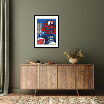 Discover the captivating 'Still life with Roses, 2014' by Faisal Khouja: a black framed fine art print featuring a linocut-style painting. With vibrant hues of intense blue, reds, and whites, this artwork showcases Faisal's intricate yet vibrant style, depicting a vase of roses, a lamp, and a bowl of strawberries.