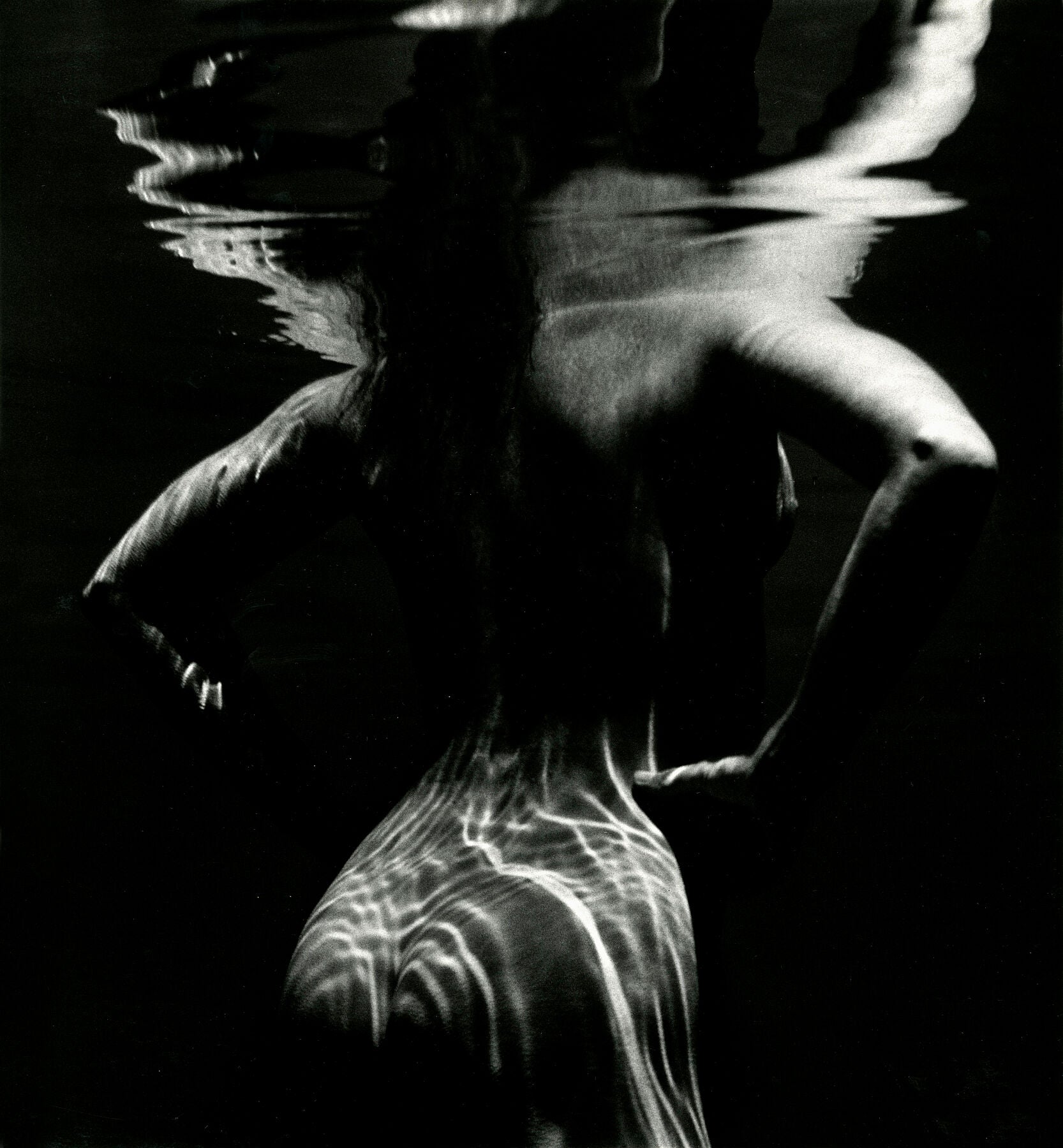 Unframed print 'Underwater Nude' by Brett Weston: A nude figure underwater creates a dramatic black & white abstract composition. 