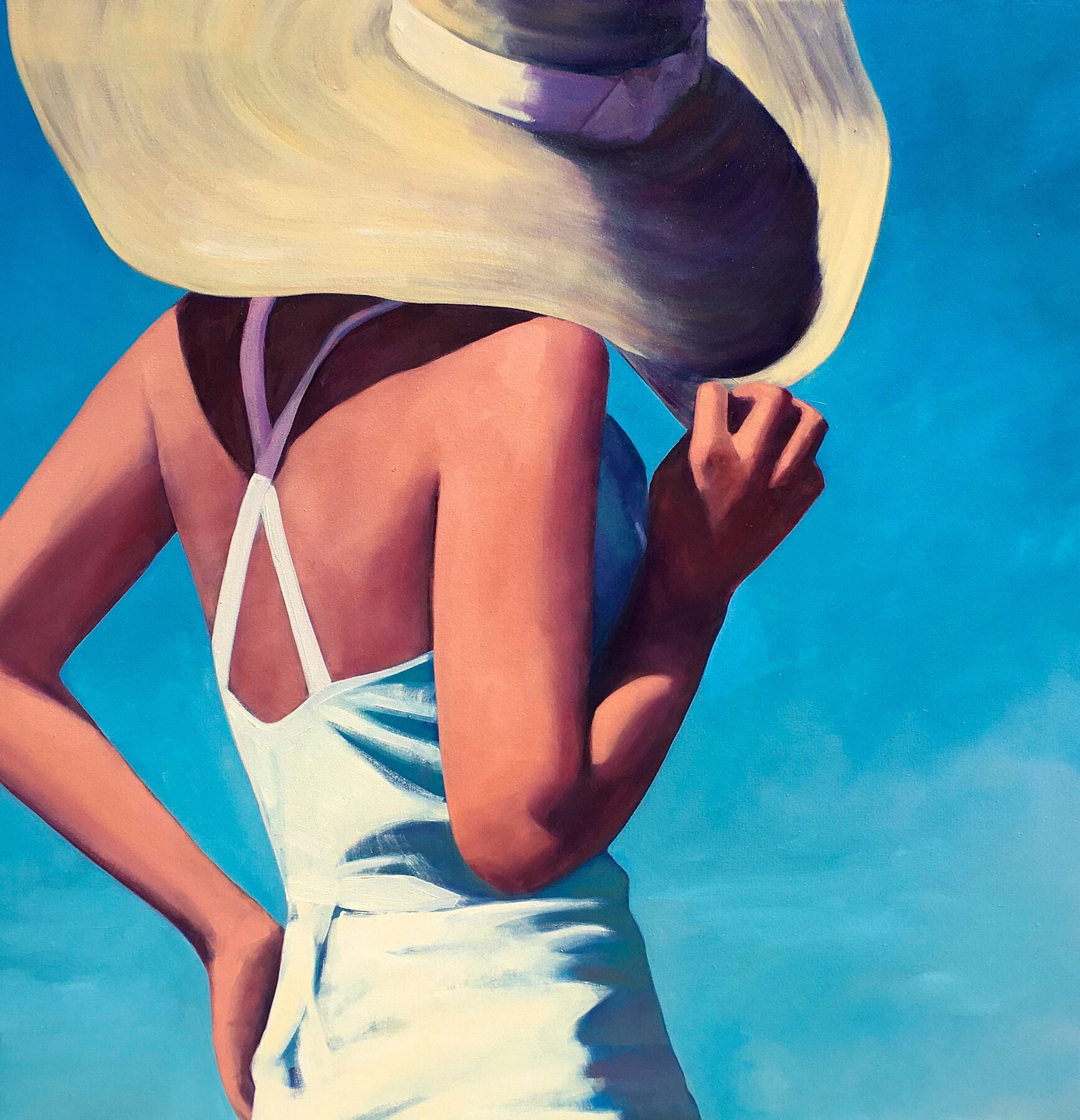 "Sunlight" blends nostalgia with vibrant colours and shows a woman in a white outfit, her back to the viewer, standing against a blue background. One of her hands sits on her hip, while the other toys with her large sunhat. Painting by T.S. Harris. 8365615